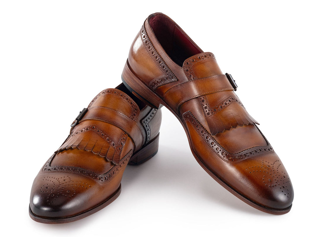 Handcrafted men's monkstrap shoes in brown leather with intricate detailing and kiltie