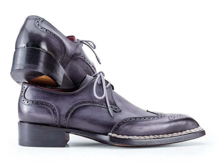  Handcrafted leather shoes with classic wingtip design 